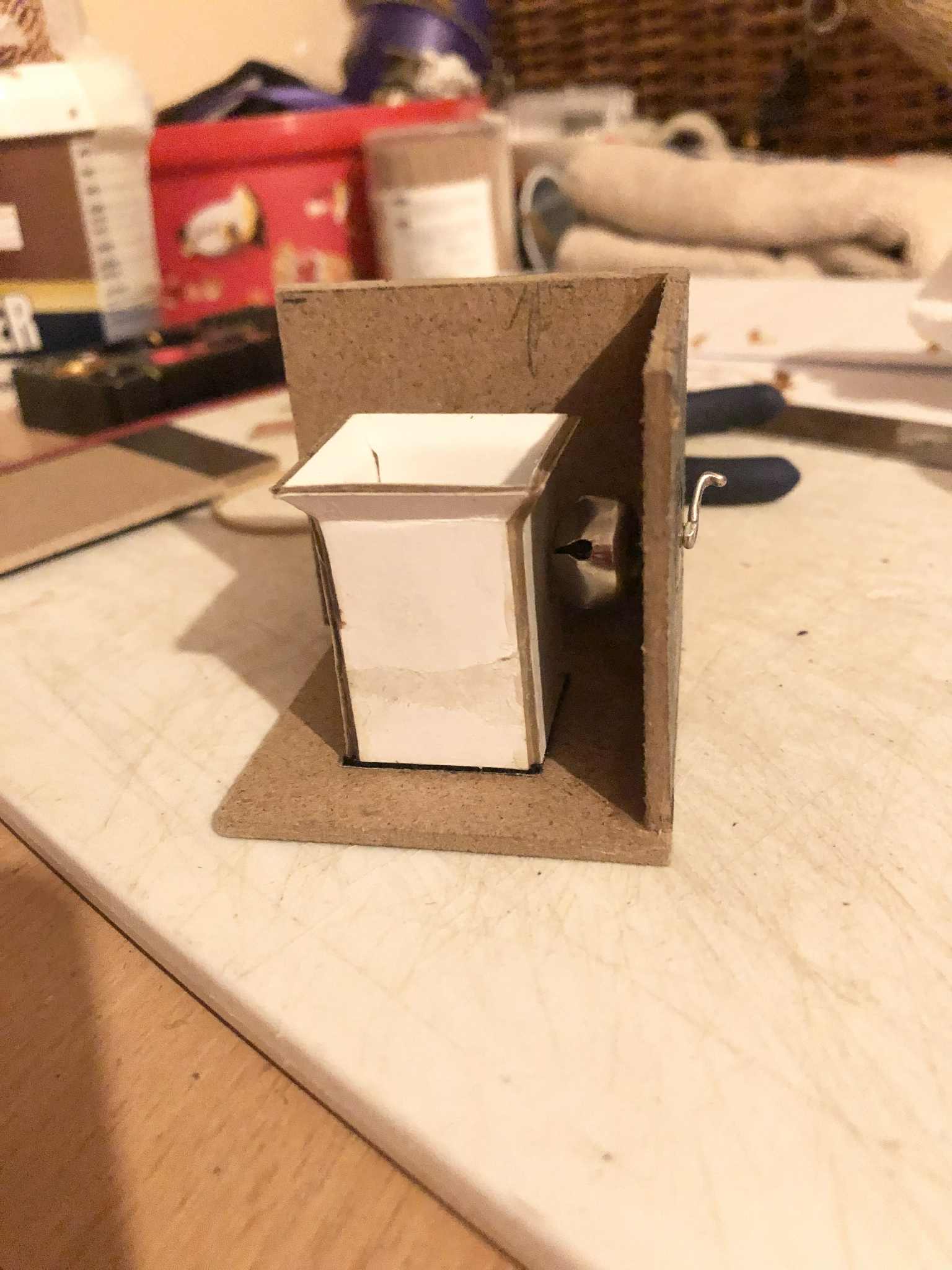 A look at the inside of the box, showing that the jingle bell is attached directly to the crank, and has a minor gap between the inner space for the sticks and itself.