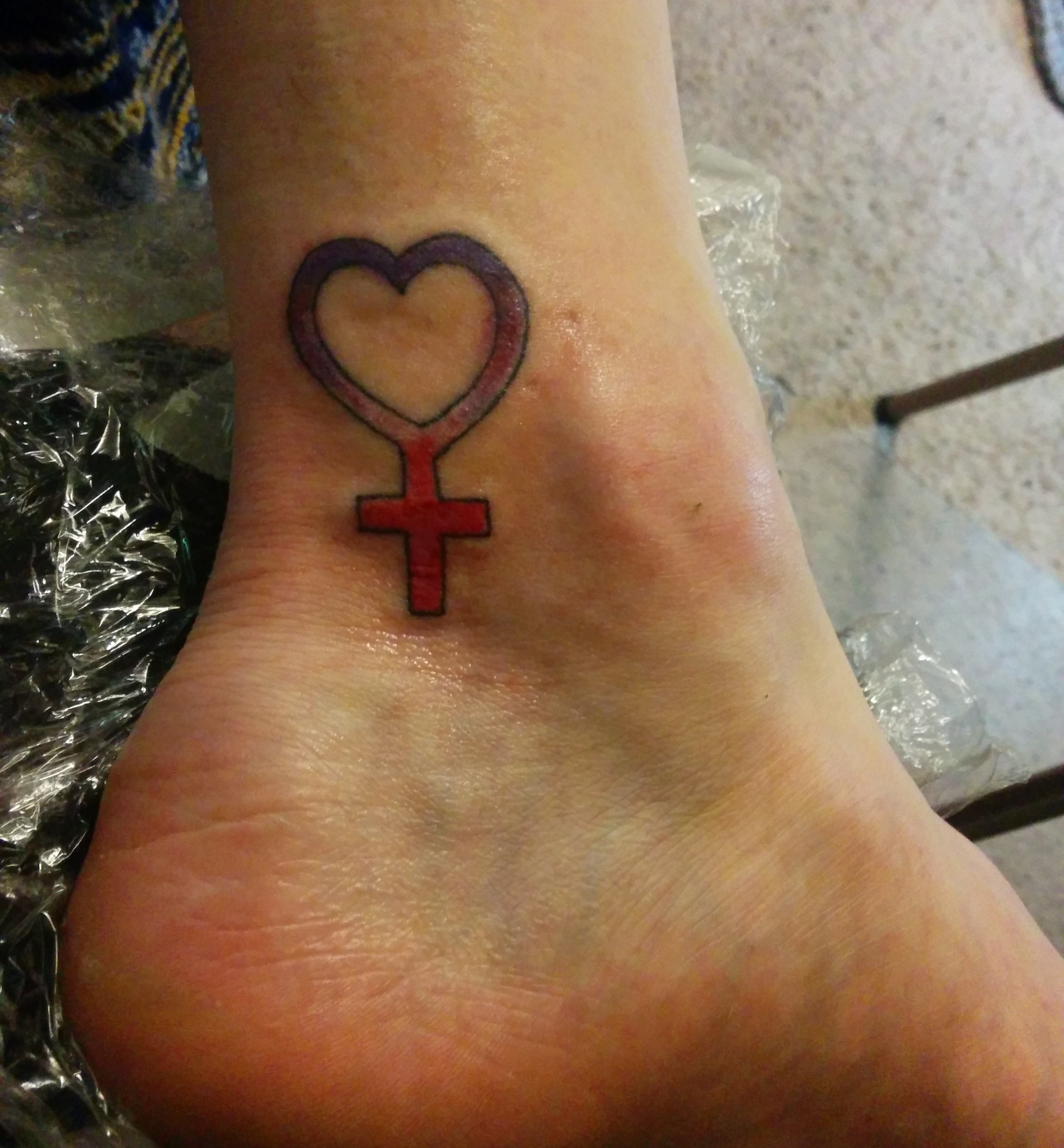 The female symbol on her ankle