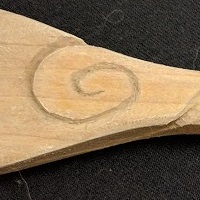 The swirly pattern on the spoon, close up