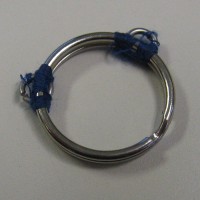 A keyring held open with two small chainmaille rings and thread