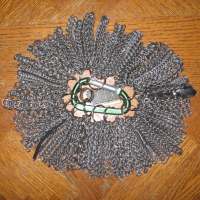 About fifty different chainmaille weaves, all attached to a green caribiner