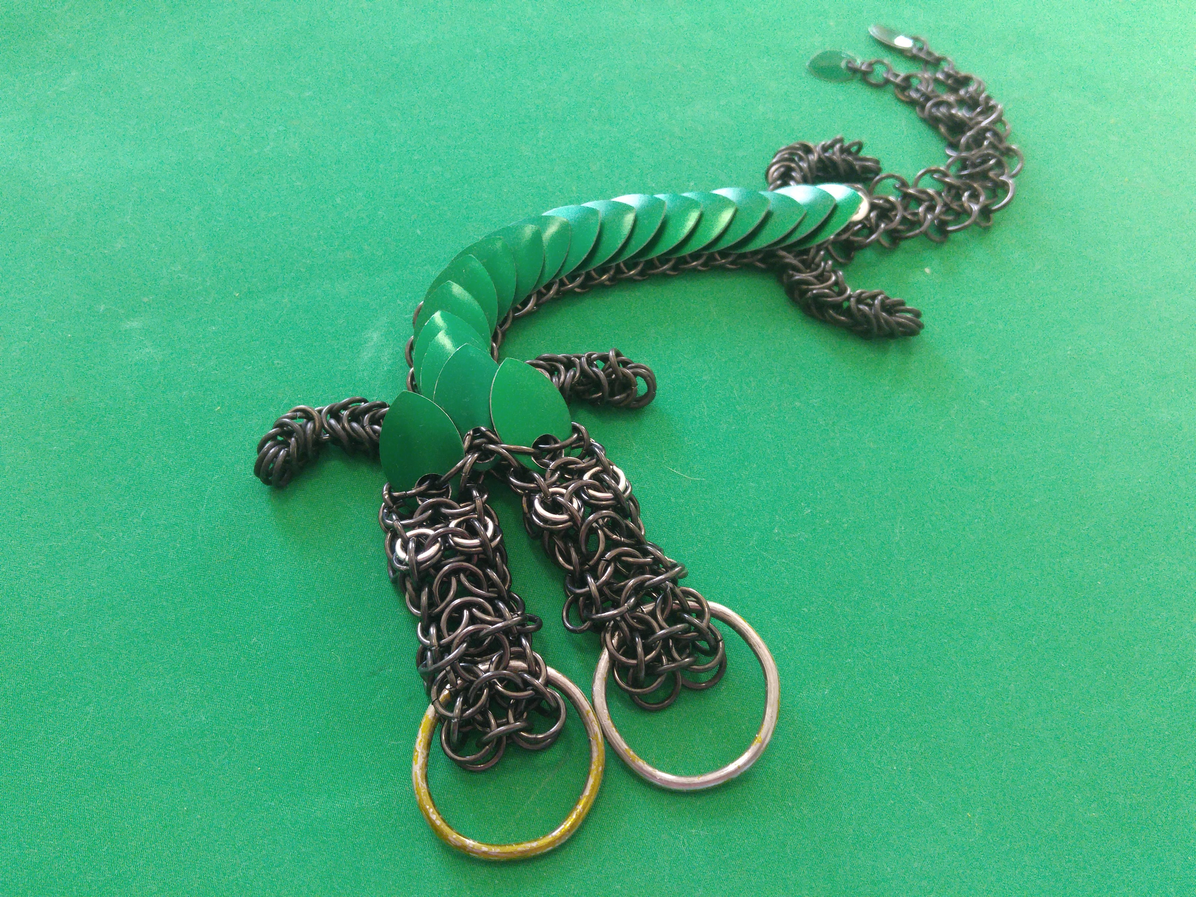 A green two-headed chainmaille dragon.