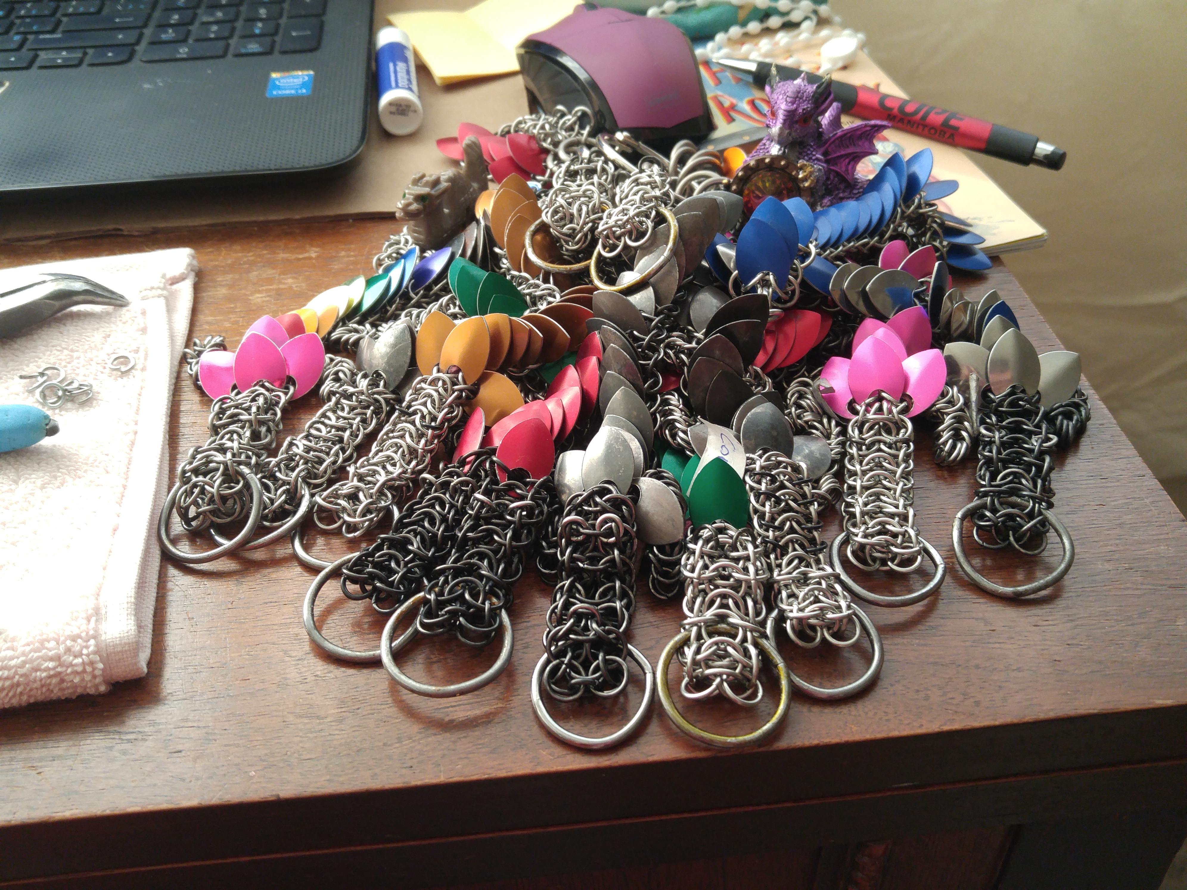 A whole big pack of chainmaille dragons in a pile!