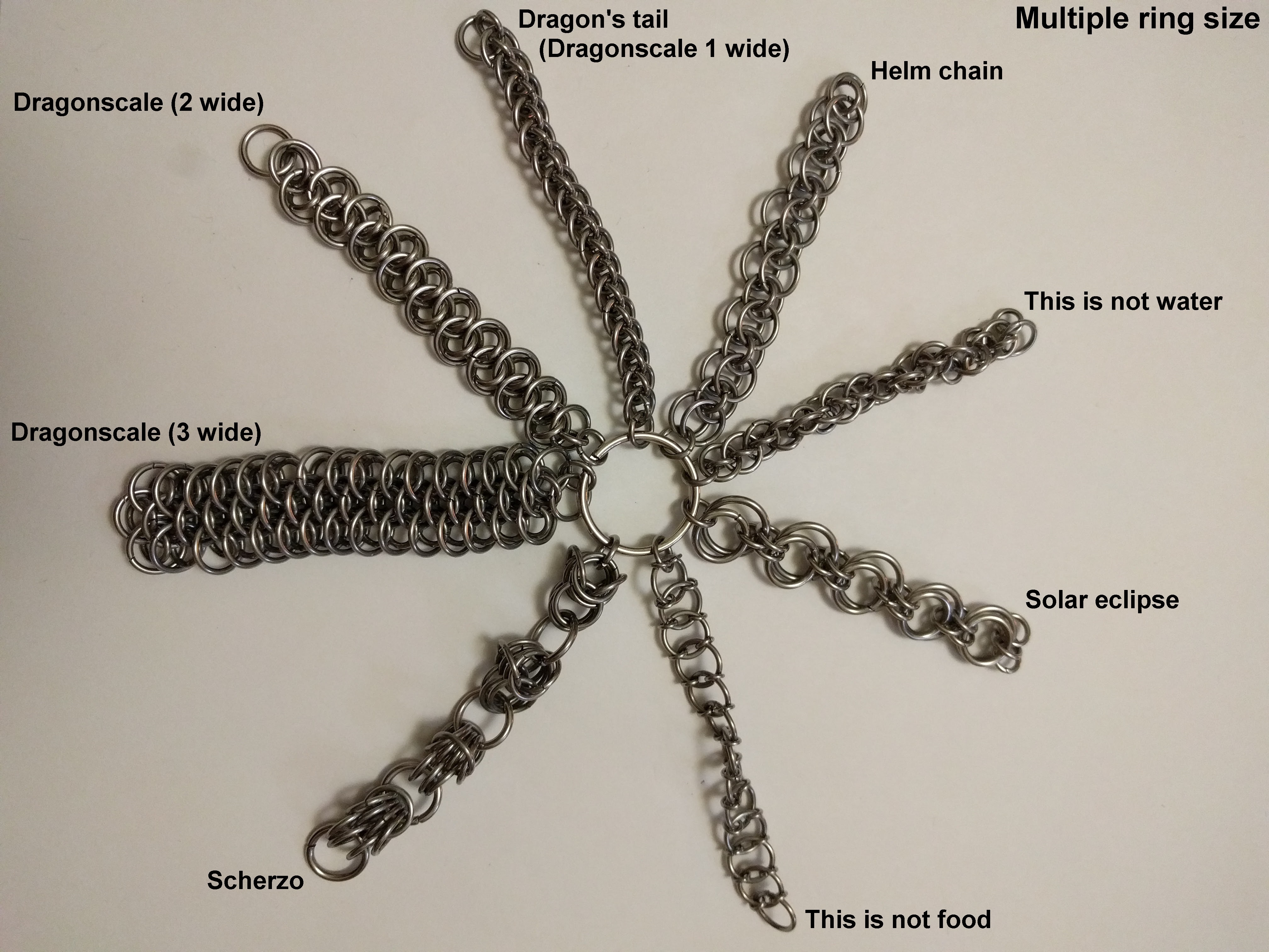 The weaves that use multiple ring sizes connected to a central ring, and spread out on a white surface.