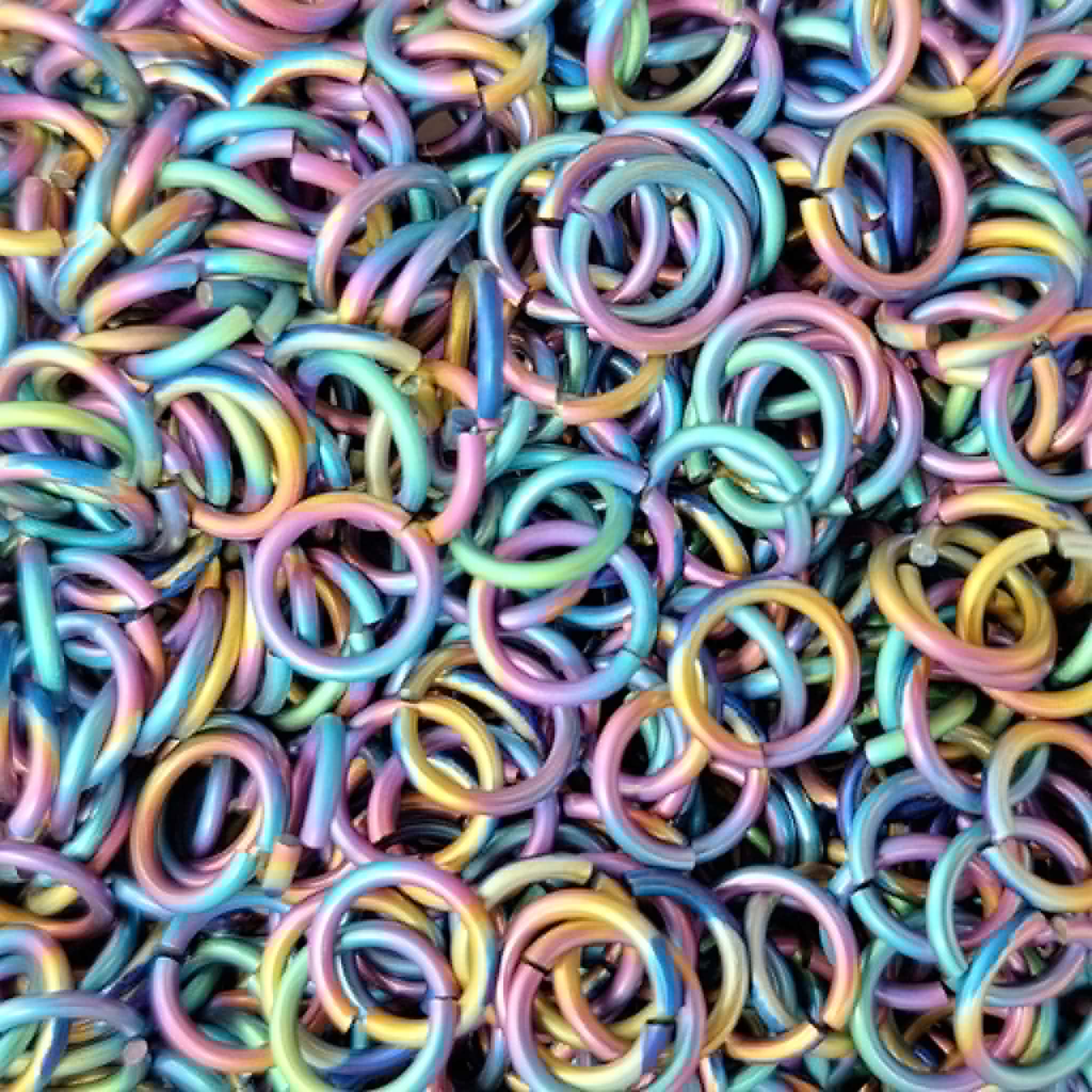 A chainmaille wrapped coin.