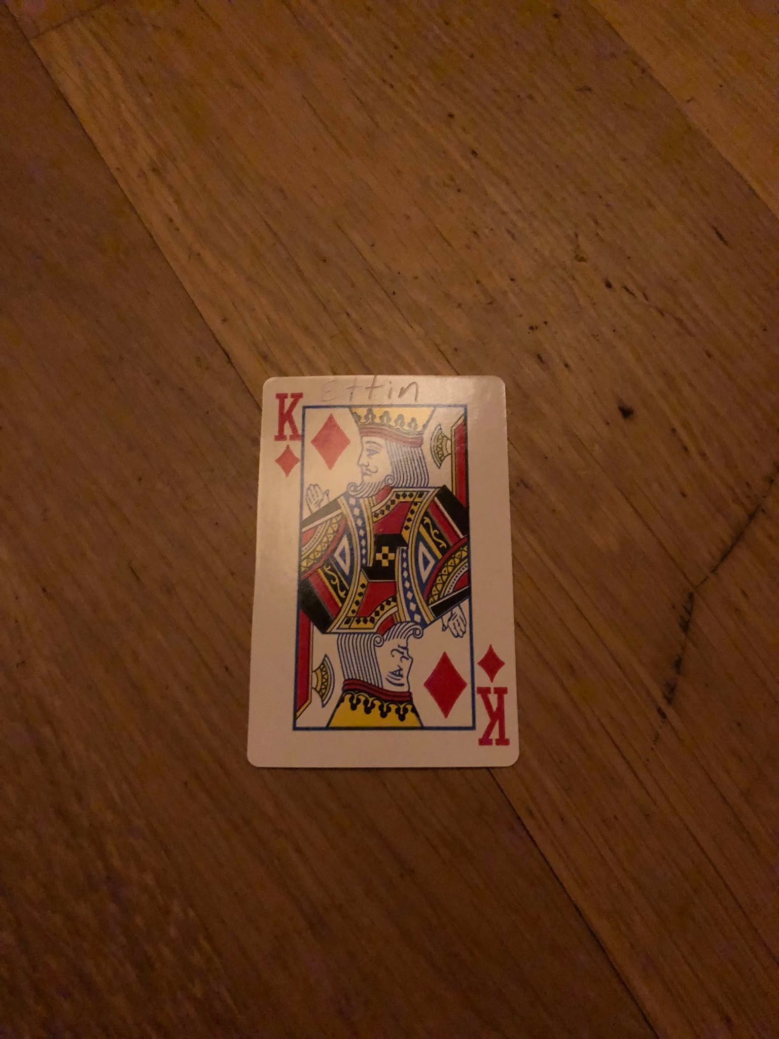The king of diamonds, thrown to the floor in front of the creature.