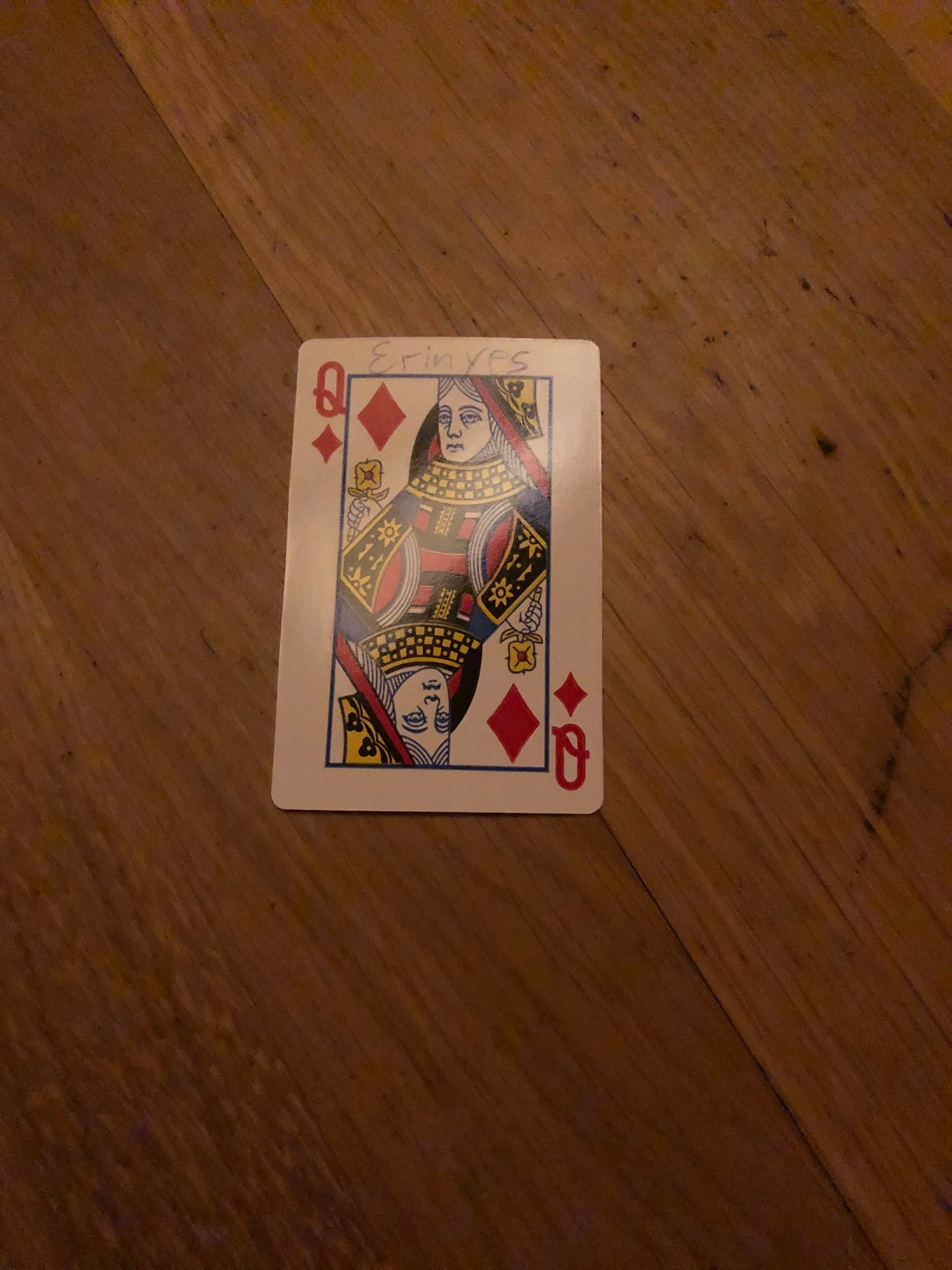The queen of diamonds, thrown to the floor in front of the creature.