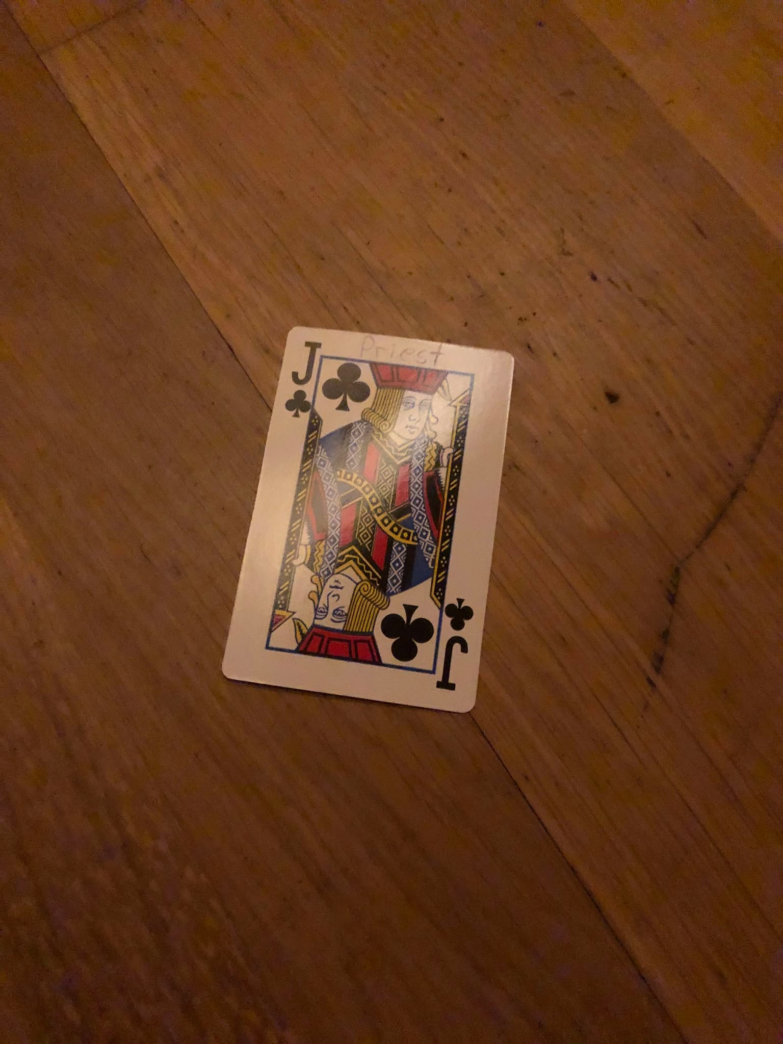 The jack of clubs, thrown to the floor in front of the creature.