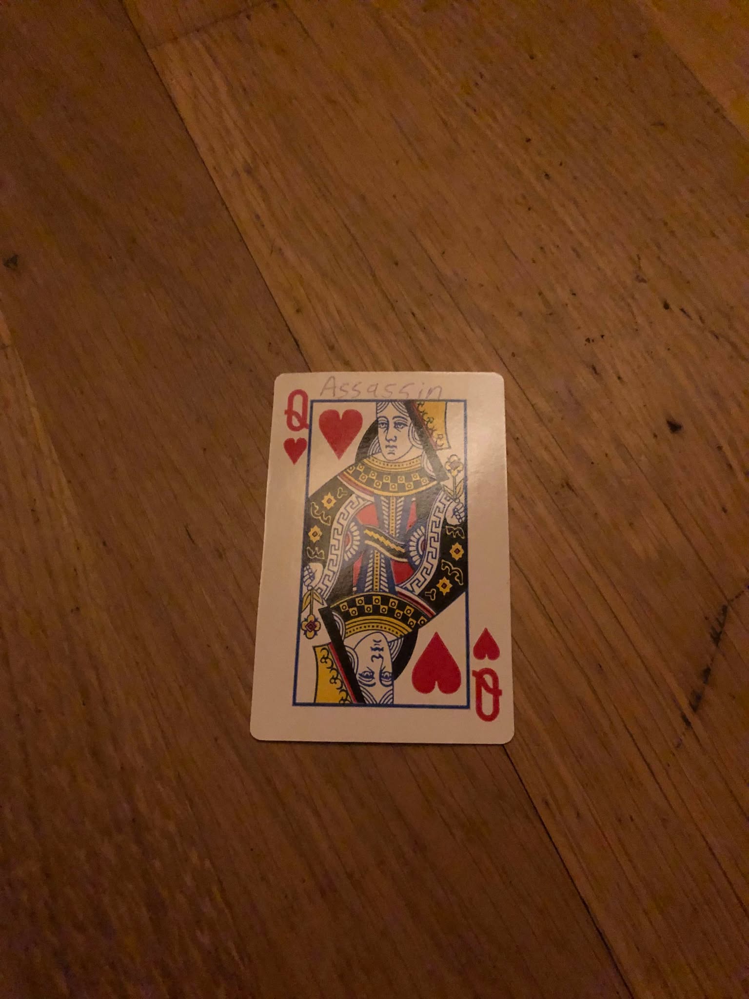 The queenof hearts, thrown to the floor in front of the creature.