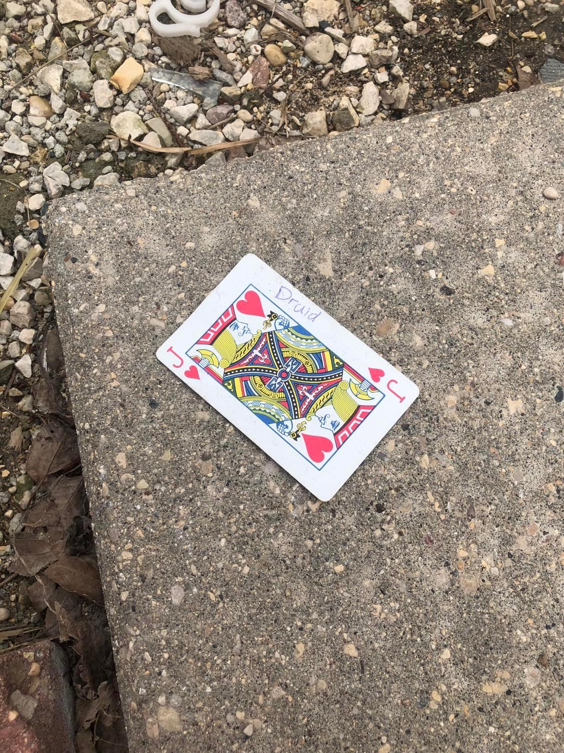 The jack of hearts, laying on the ground before the creature.