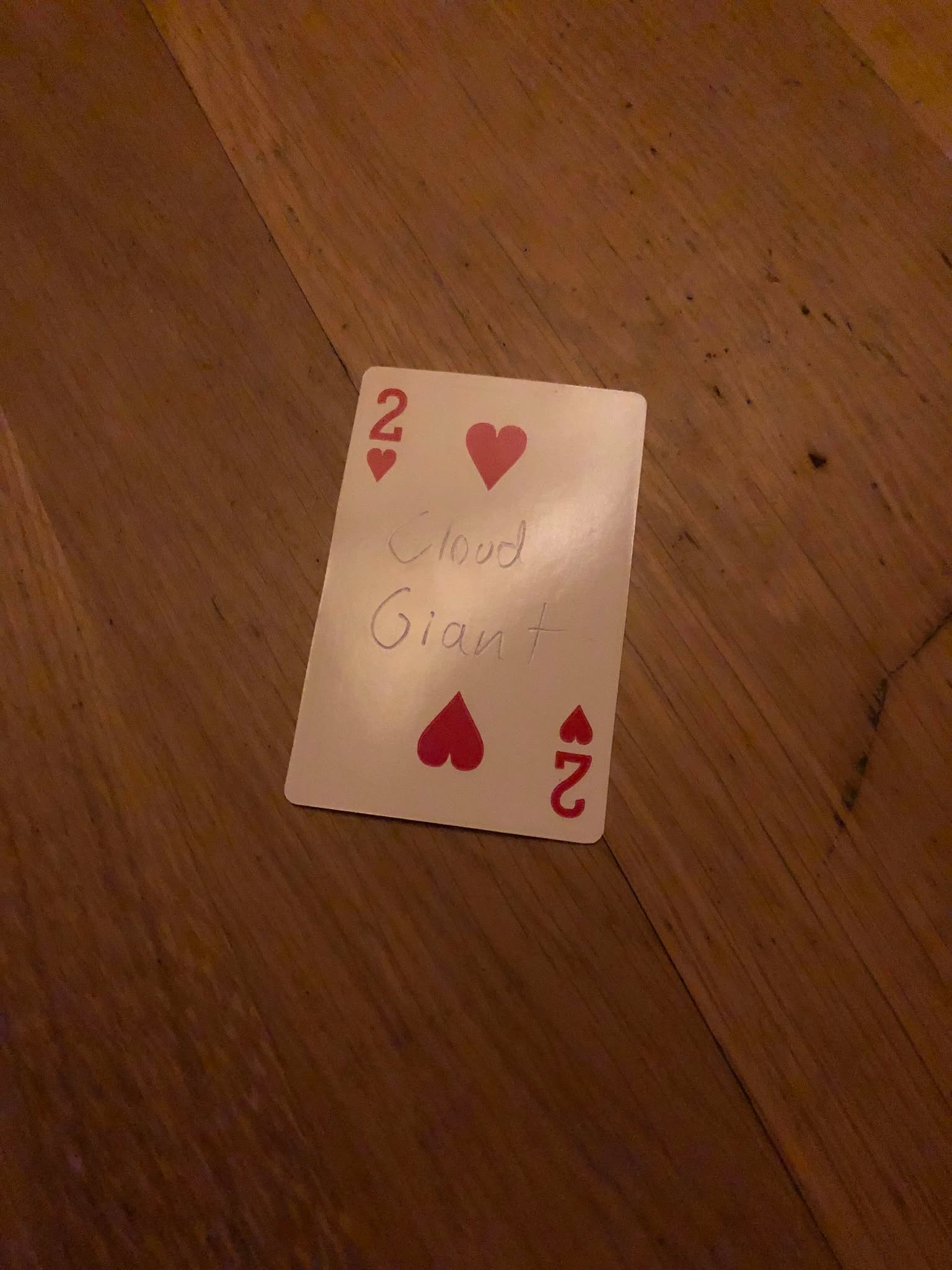 The two of hearts, thrown to the floor in front of the creature.