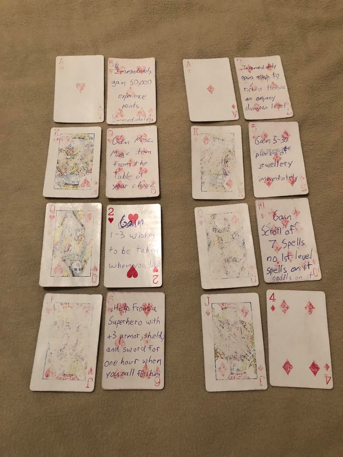 Several cards laid out, showing a substitute card beside the proper one. The text for the cards has been written, sometimes off-alignment and then corrected, on the substitute cards, the first seven of which are filled out.
