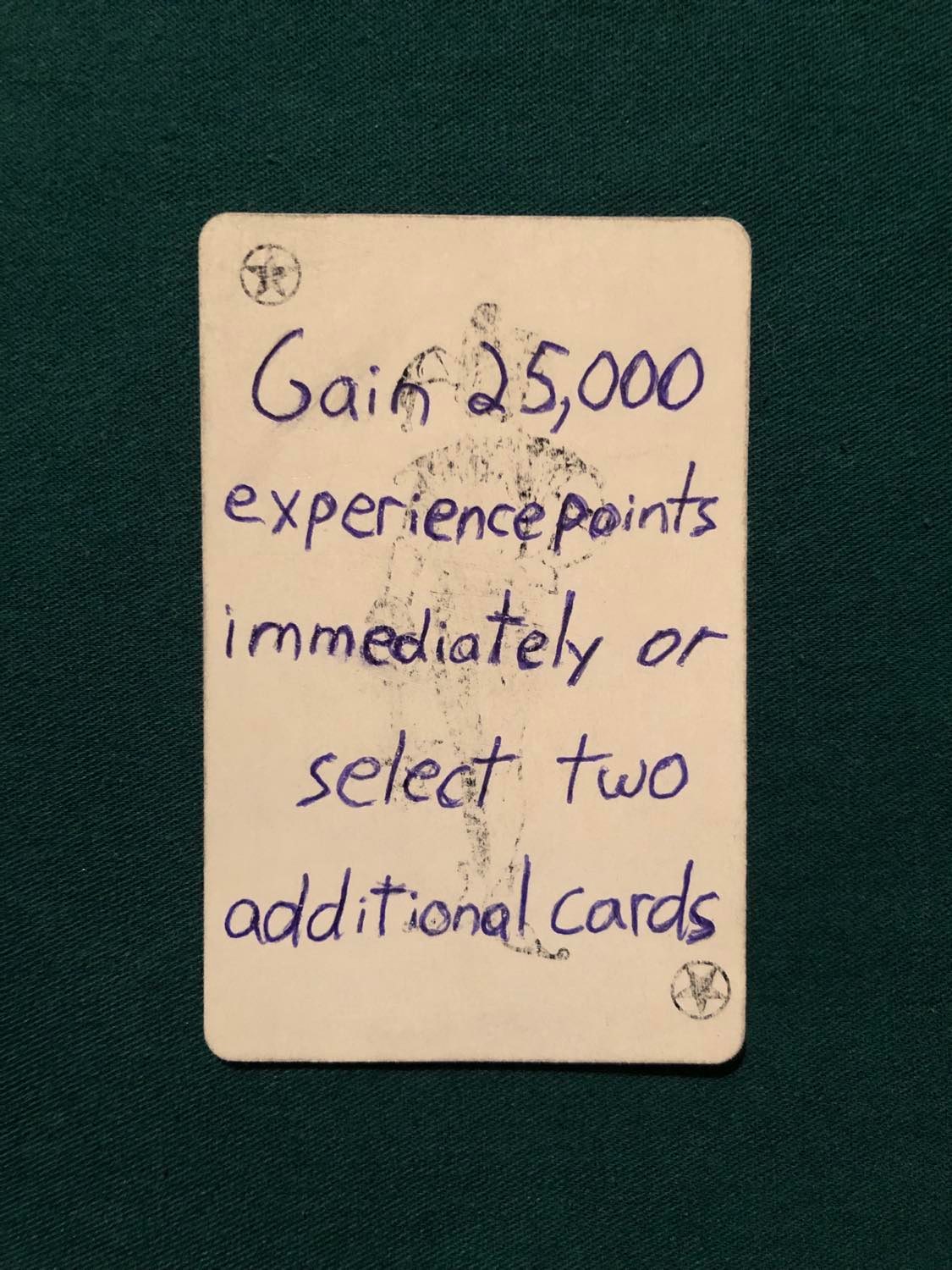 The starred joker, laying on a green fabric.