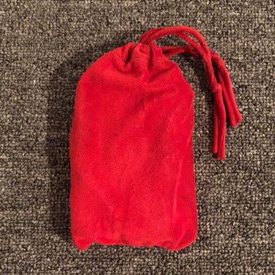 A red pouch on a dark grey carpet