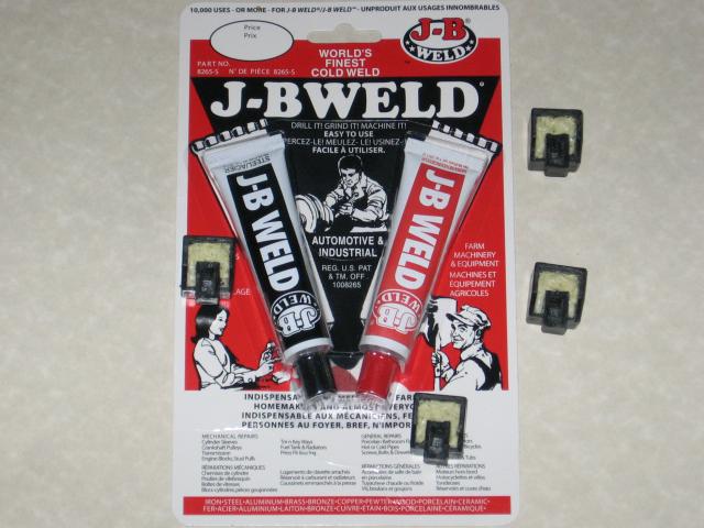 A package of JB Weld, you will come to know it on this site. I link to this stuff often because it's SO incredible, and becomes a rock solid plastic. It's red and black packaging, with a black tube and a red tube, which actually contains white paste, arranged in a V and shrink-wrapped onto the packaging, with several illustrations of people using it on the back. There are four Rubik's cube pieces, mostly filled with foam, sitting on and around the JB Weld.