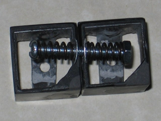 A closeup of the inner springs, holding two pieces together while allowing them to rotate, with the metal washers guarding the plastic from the springs.