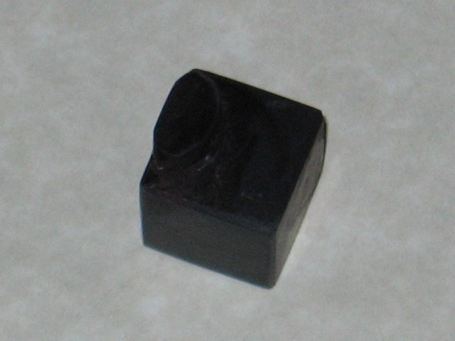 One of the cubies, with the grey covered up and now black like the rest of the plastic.