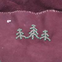 Three beaded spruce trees on brown leather, small moon in the top left