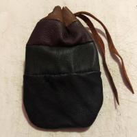 A brown leather pouch on a white backdrop