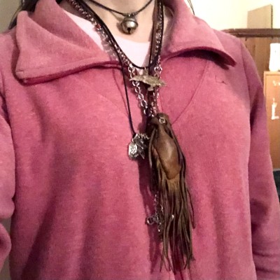 A handful of various necklaces worn around Kabutroid's neck, with a pink sweater beneath