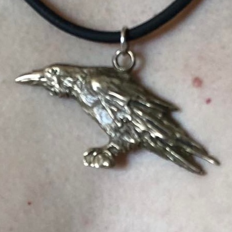 A bronze crow pendant