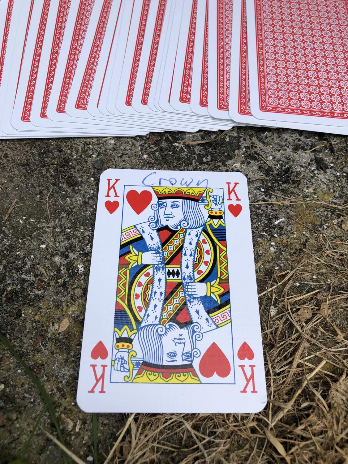 The king of hearts with the word Crown written on it, laying on the bridge support.