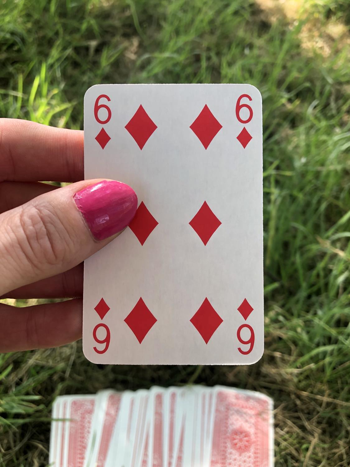 The six of diamonds, held up from the drawn out cards.