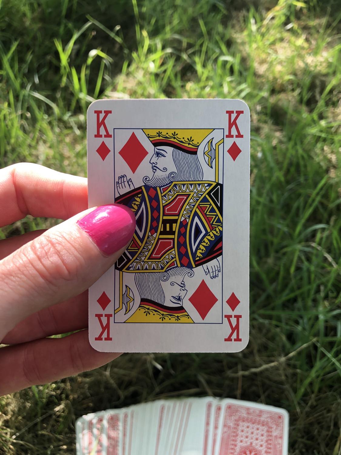 The king of diamonds, held up from the drawn out cards.