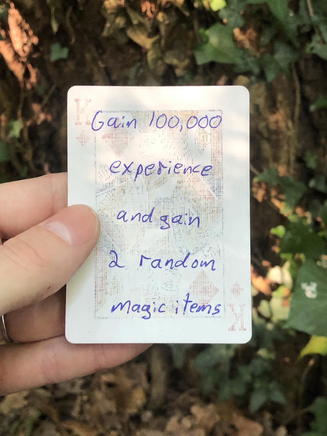 The king of diamonds, held above the detritus on the ground. Gain 100,000 experience, and gain 2 random magic items.