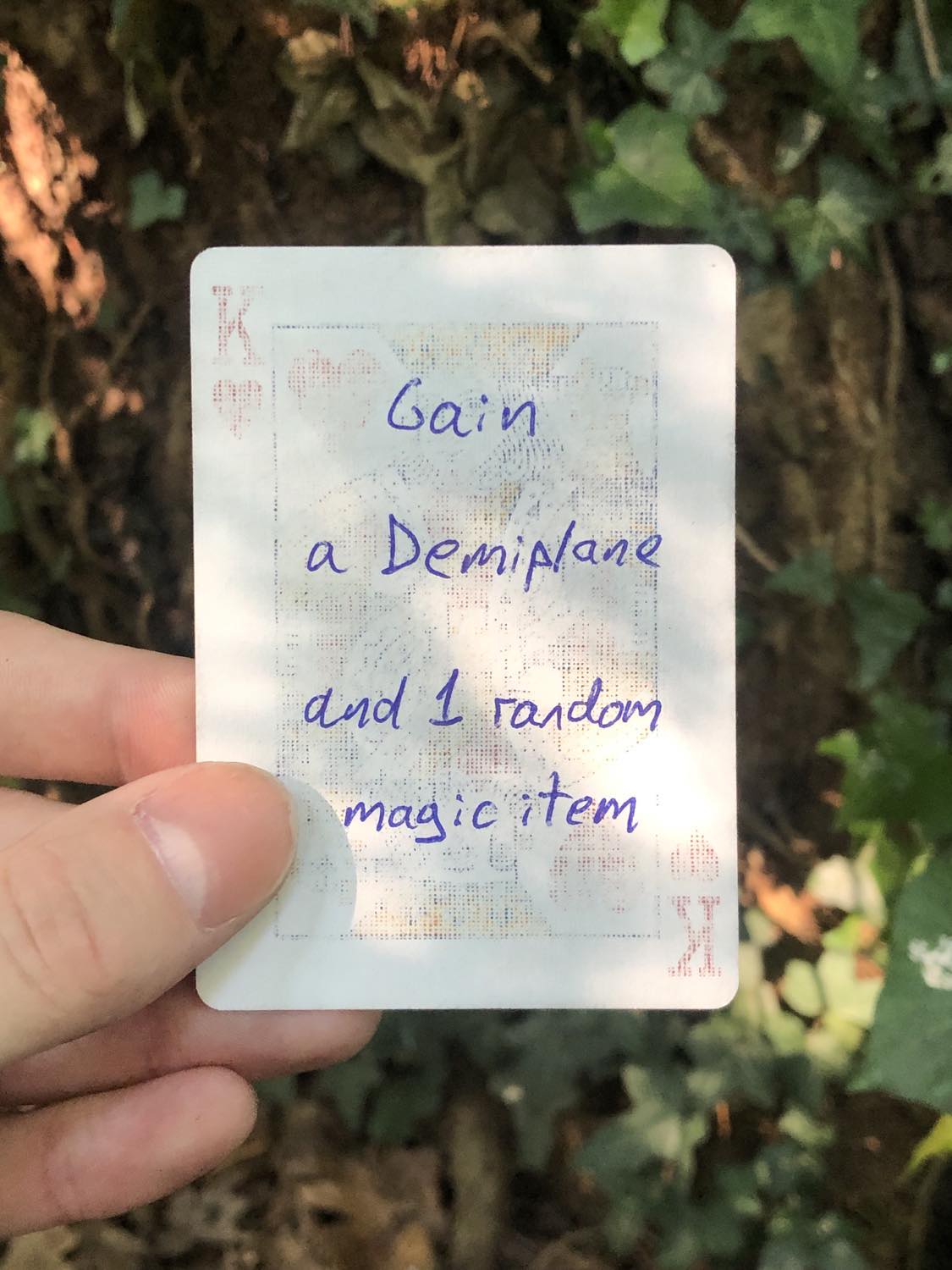 The king of hearts, held above the detritus on the ground. Gain a Demiplane and 1 random magic item.